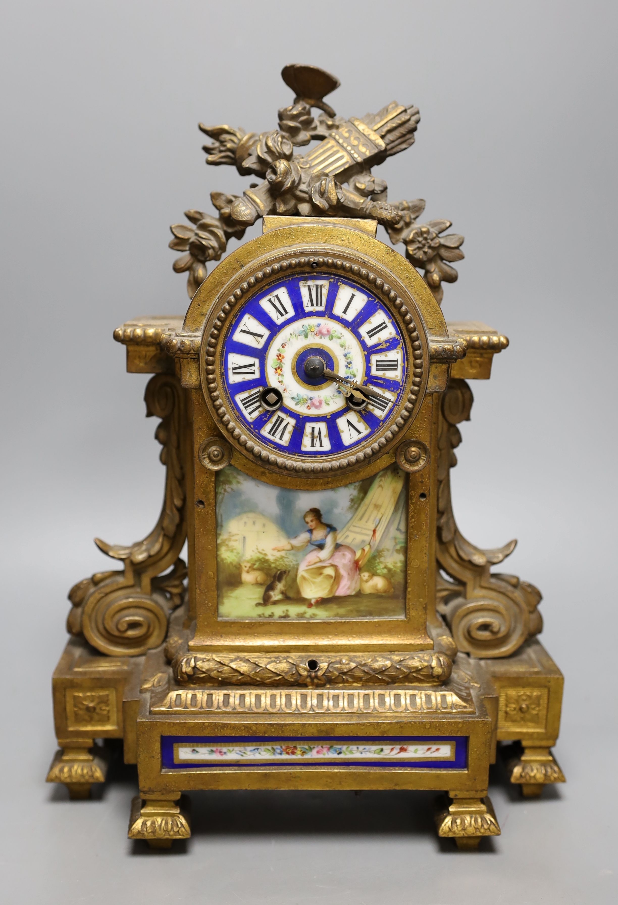 A 19th century French gilt metal and porcelain mantel clock, 36cm high